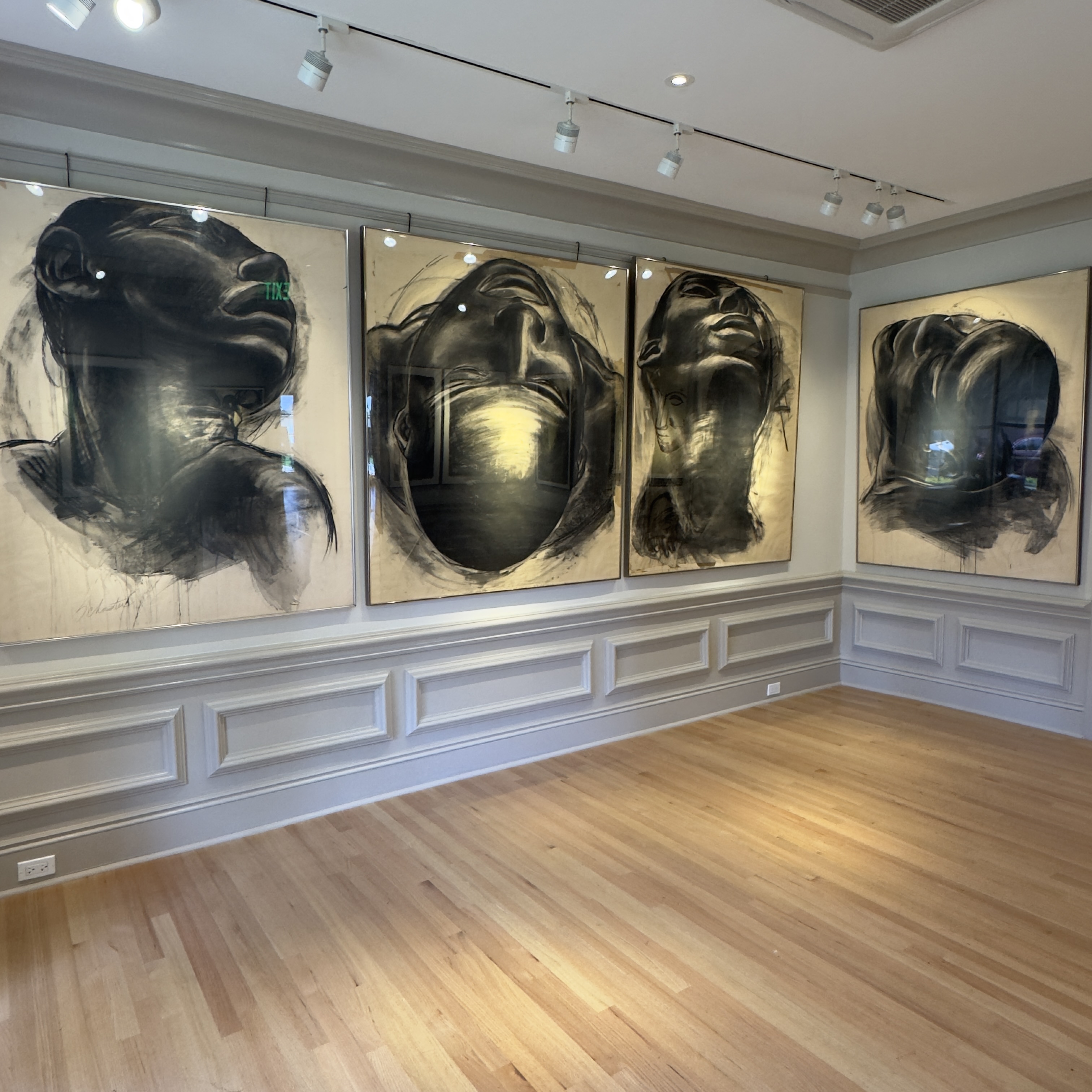 Four large charcoal head portraits installed at the Ann Norton Sculpture Gardens